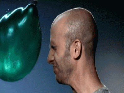 slow motion water balloon face impact