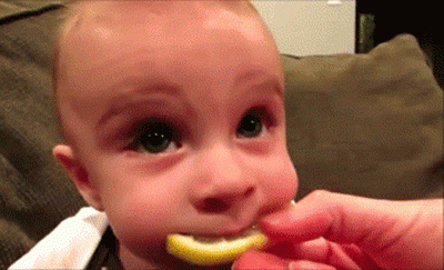 cute funny baby tries sour lemon